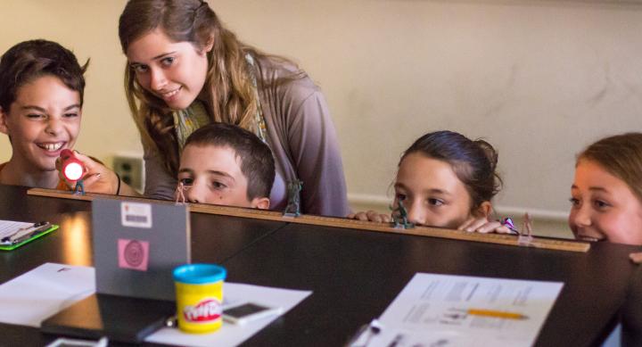 image of students at desk with flashlight